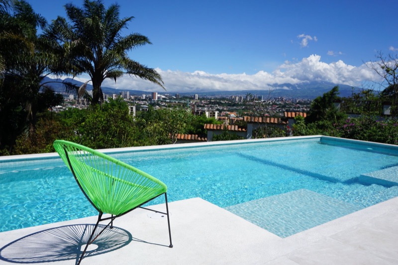 Pool at Posada El Quijote with a view over San José and the mountains