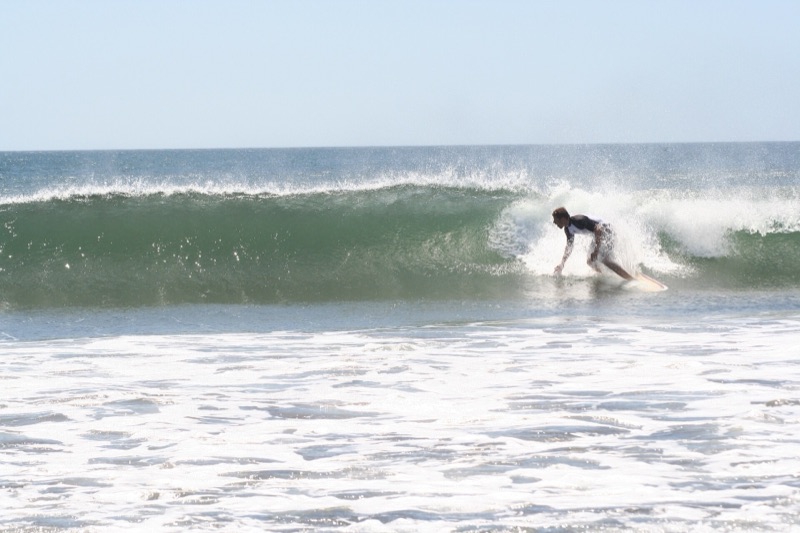 A surfer riding a wave at Witch's Rock, Guanacaste